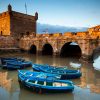 Fishing boats and historical bastion in Essaouira, Morocco.